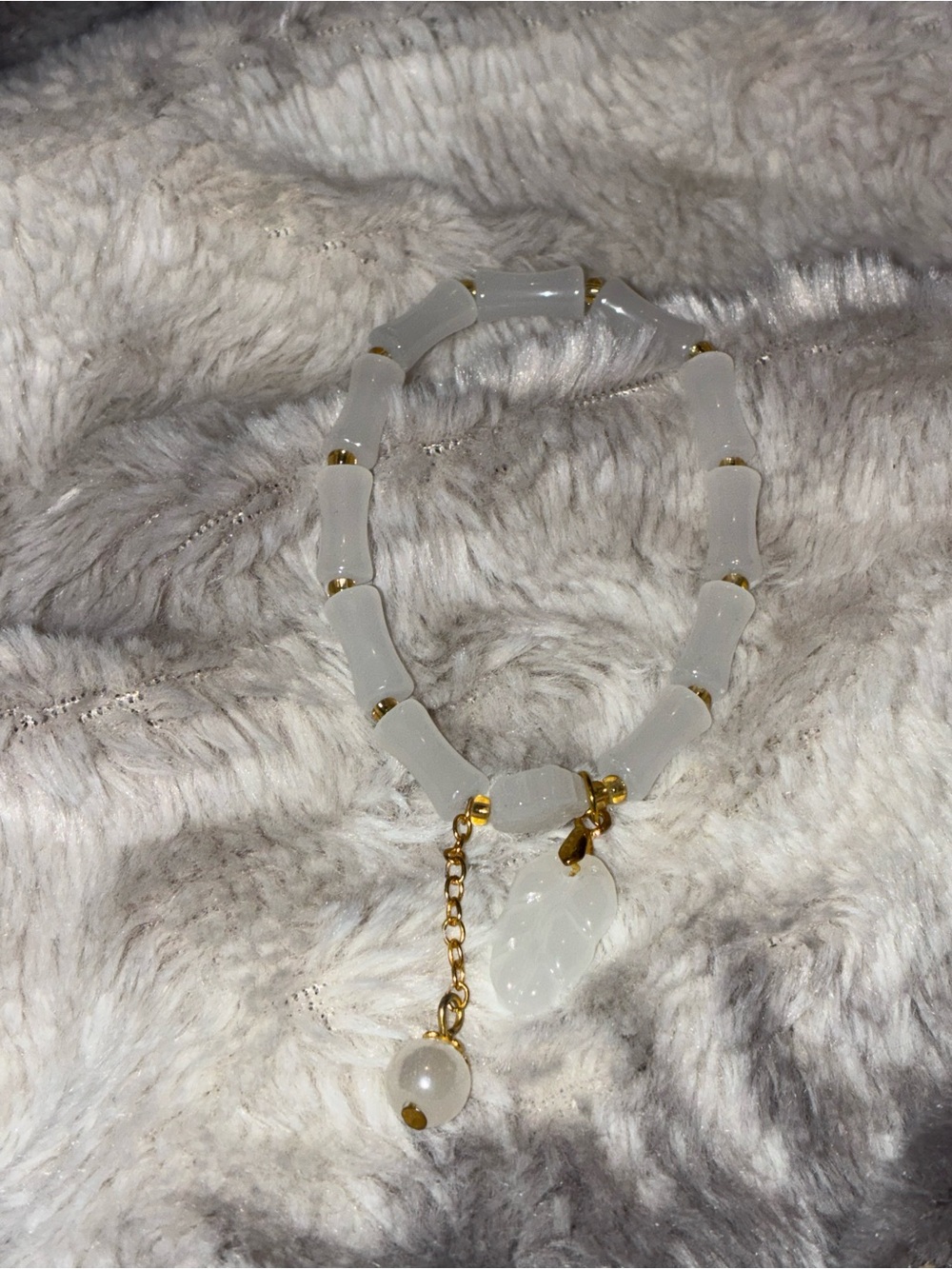 White Beaded Bracelet with Gold Accents and Leaf Charm